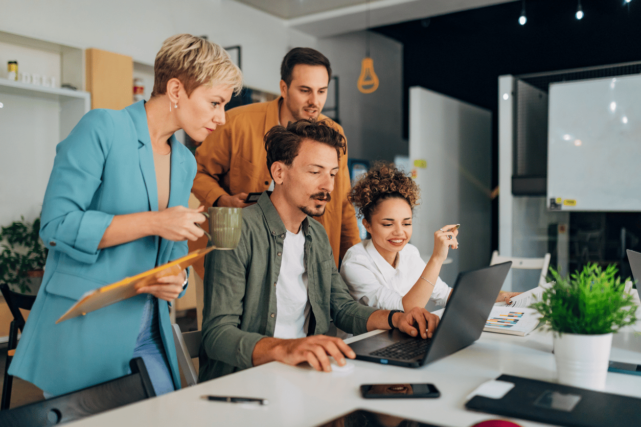 Employees learning around a computer