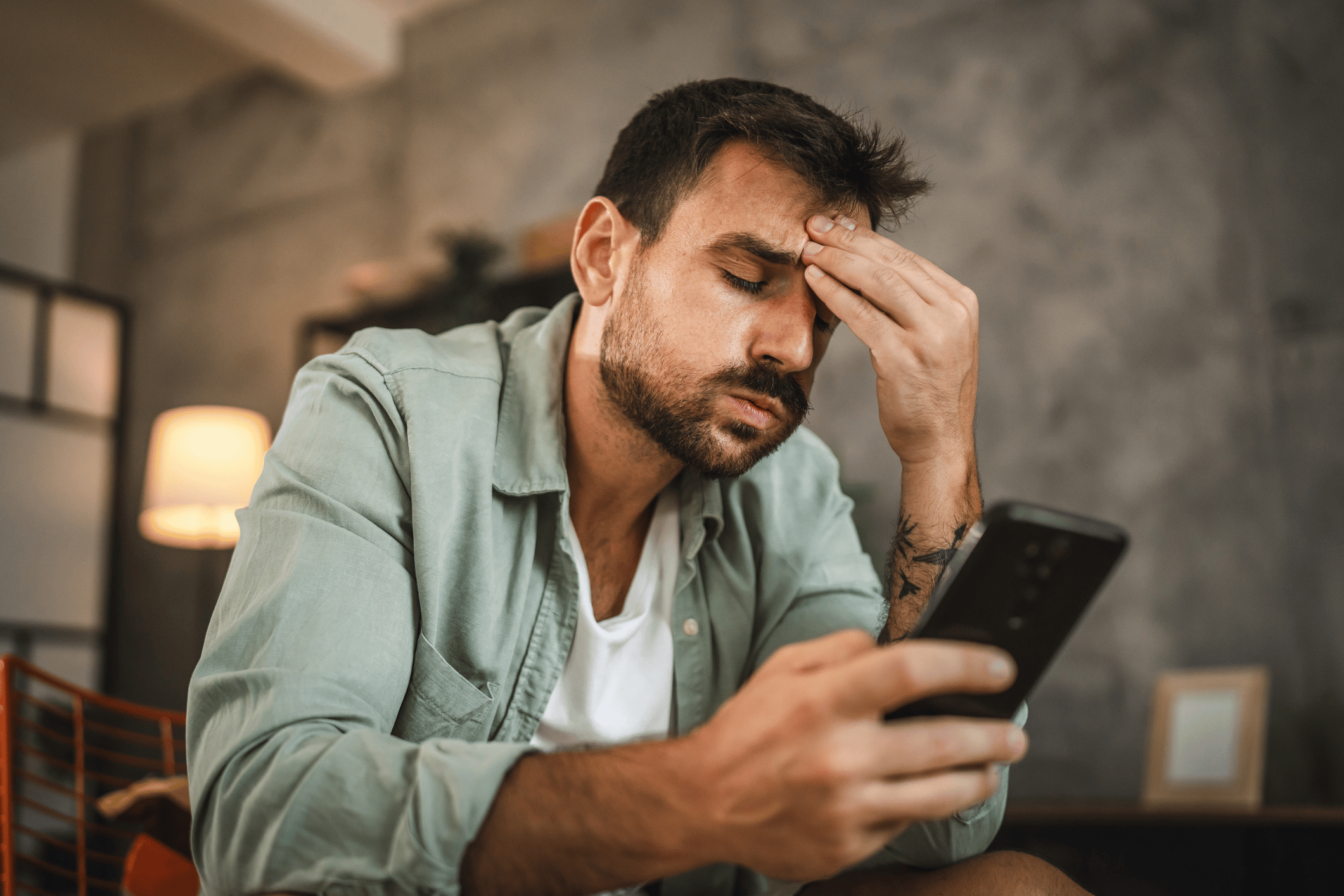Frustrated man holding phone